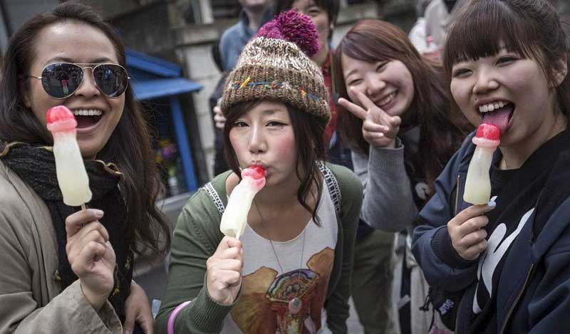 Girls posed with phallus-shaped lollipops